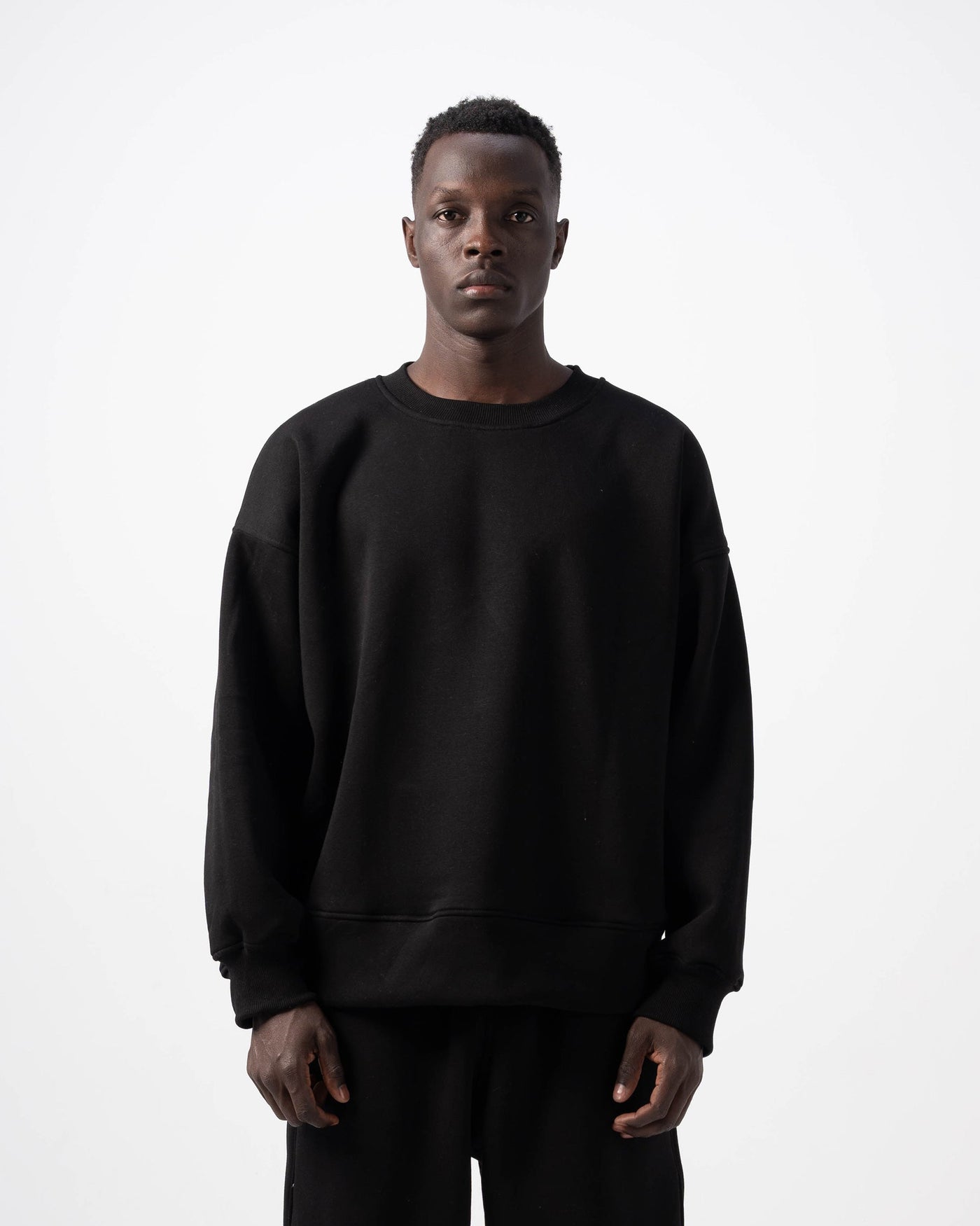 Person wearing a black outfit on a white background